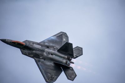 Low angle view of airplane flying against sky