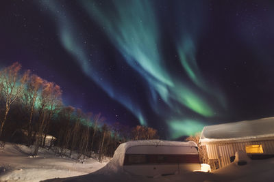 Scenic view of snow covered landscape against sky at night