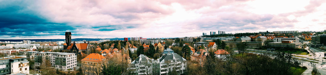 Panoramic view of cityscape against cloudy sky