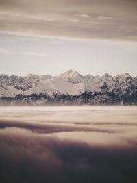 Scenic view of snowcapped mountains against sky during sunset