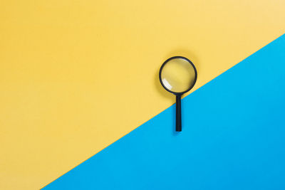 Directly above shot of magnifying glass on table