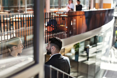 Businessmen discussing while standing on steps in office