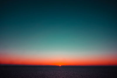 Scenic view of sea against sky at sunset