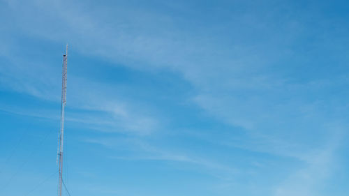 Low angle view of vapor trail against blue sky