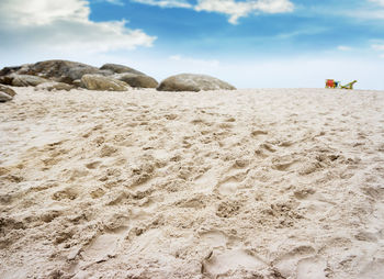 Surface level of rocks on beach against sky