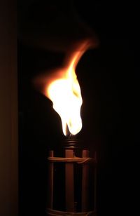 Close-up of lit candle in dark room