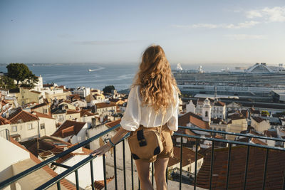 Rear view of woman looking at cityscape