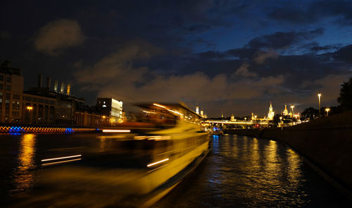 River cruise ship sails along the moscow river, night city, movement by incorporating a motion blur.