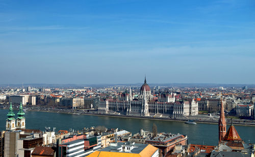 High angle view of buildings against blue sky