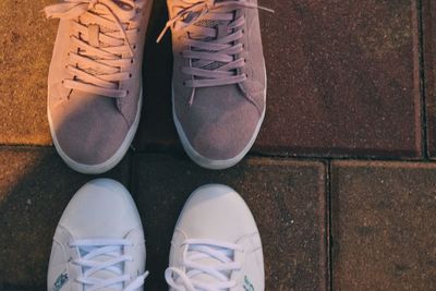 Low section of people standing on tiled floor