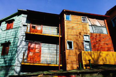 Low angle view of abandoned building against blue sky