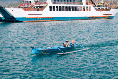 Man sitting in boat sailing on sea