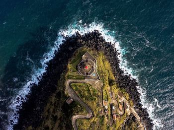 High angle view of lighthouse by sea