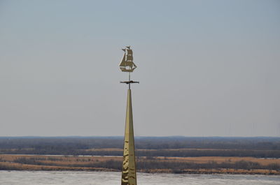 Cross on field against clear sky