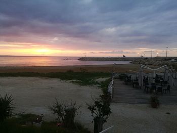 View of calm beach at sunset