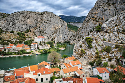 Scenic view of buildings in town against sky