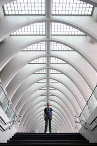 Low angle view of man walking on staircase