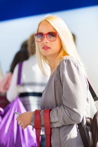 Young woman wearing sunglasses standing outdoors