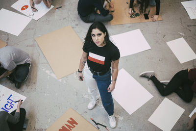 High angle portrait of woman standing on floor