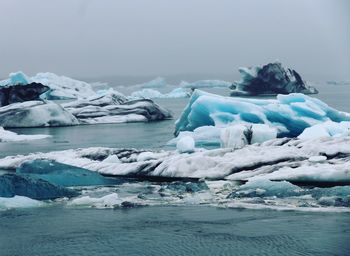 Scenic view of frozen lake against sky during winter