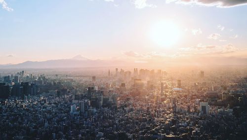 High angle view of modern buildings in city against sky during sunset
