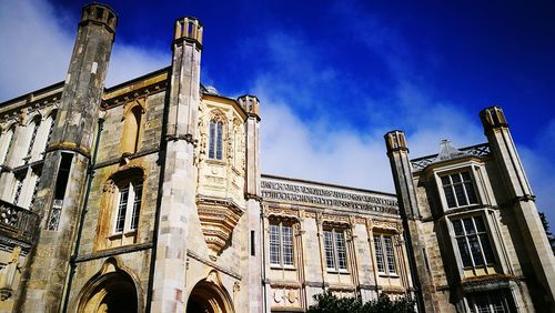 Low angle view of historical building against blue sky