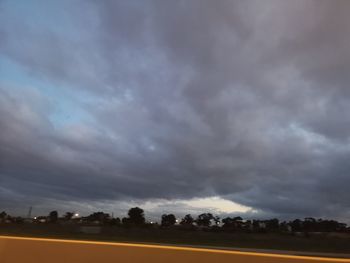 Scenic view of field against cloudy sky