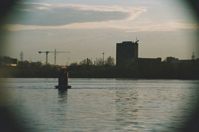 Reflection of buildings in water at sunset