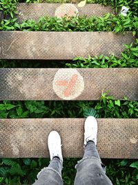 Low section of man standing on steps outdoors