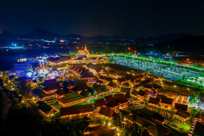 High angle view of illuminated buildings in city at night