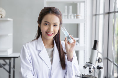 Portrait of young businesswoman working in laboratory