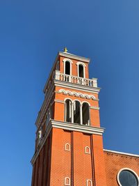 Low angle view of building against clear blue sky