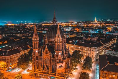 High angle view of city lit up at night