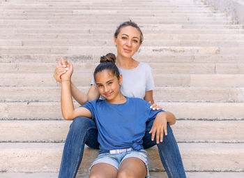 Portrait of smiling boy sitting on steps