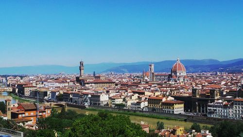 Duomo santa maria del fiore amidst buildings against clear blue sky on sunny day