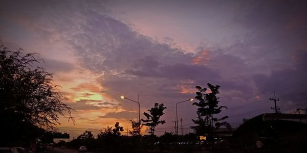 Low angle view of silhouette trees against sky at sunset