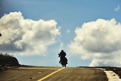 Man on road against sky