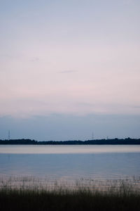 Scenic view of lake against sky during sunset