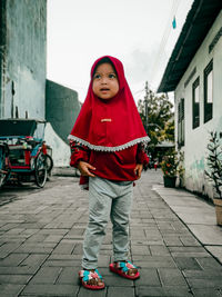 Full length portrait of girl standing in city
