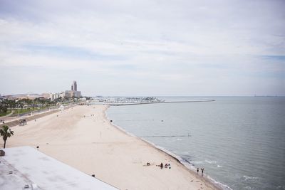 Scenic view of beach against cloudy sky