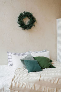 Christmas decor in the bedroom and a wreath on the wall in the scandinavian style interior