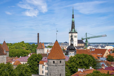 Scenic view of gothic church and houses in old historic townscape against sky