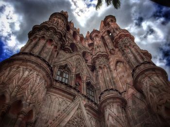 Low angle view of historical building against cloudy sky