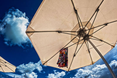 Colorful weap hanging under a beach umbrella