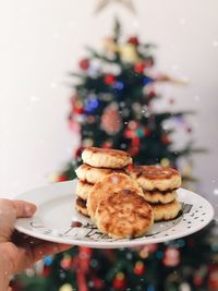 Close-up of hand holding pancakes 