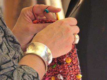 Cropped hands of woman knitting