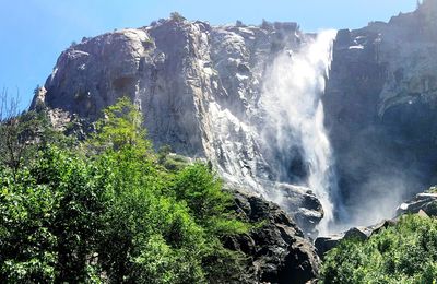 Low angle view of waterfall against sky