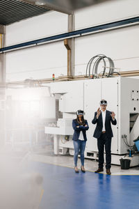 Businessman an woman in high tech enterprise, using vr glasses