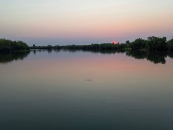 Scenic view of lake against sky during sunset