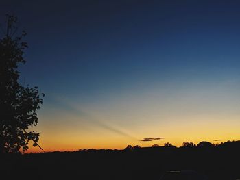 Scenic view of silhouette landscape against clear sky at sunset